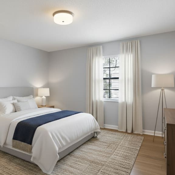 a bedroom with a bed, nightstand, and a plant on a dresser.