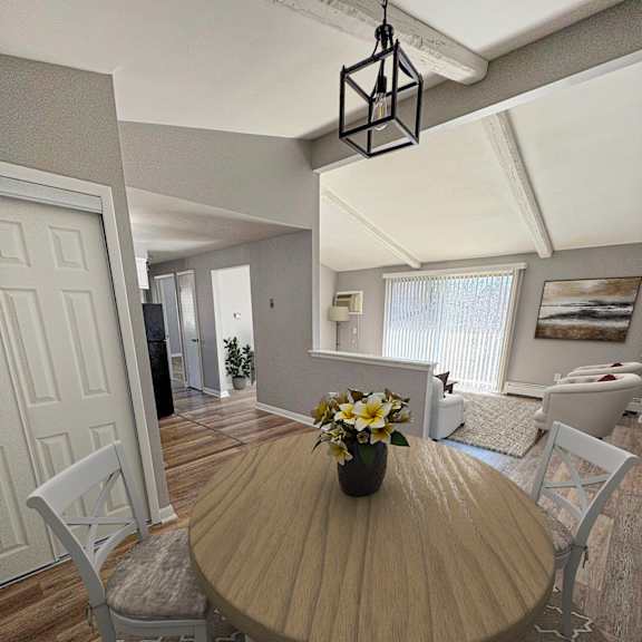 a dining room with a wooden table and chairs.