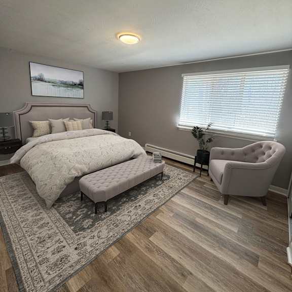 a bedroom with a large bed and a chair.