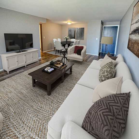 a living room with a white couch and a brown coffee table.