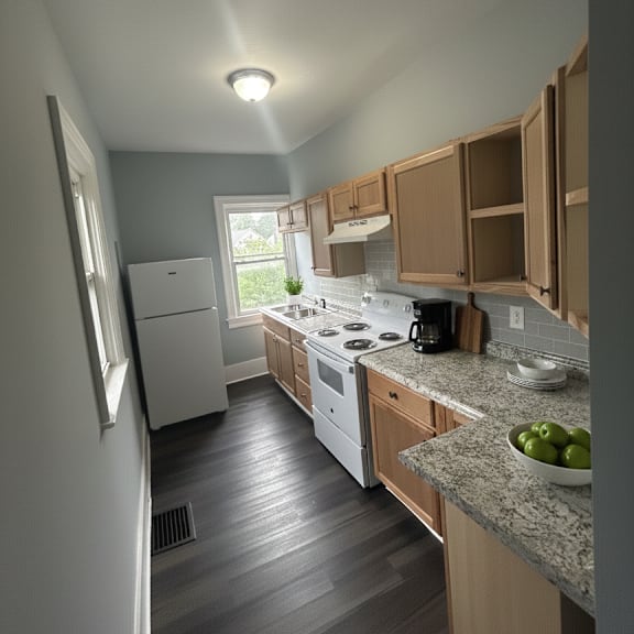 a kitchen with wooden cabinets and a granite countertop.