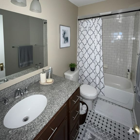 a bathroom with a white sink and a white toilet.