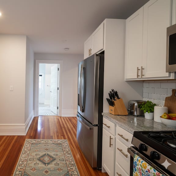 a kitchen with a refrigerator, stove, and oven.