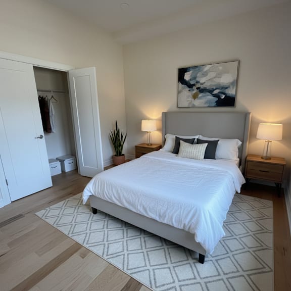 a bedroom with a large bed and a painting above it.