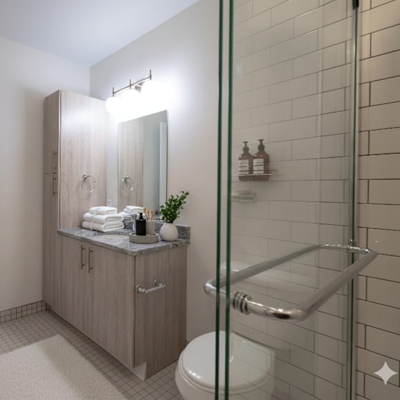 a bathroom with a toilet, sink, and shower.