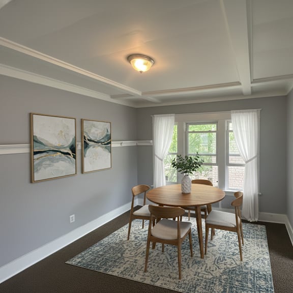 a dining room with a table and chairs.