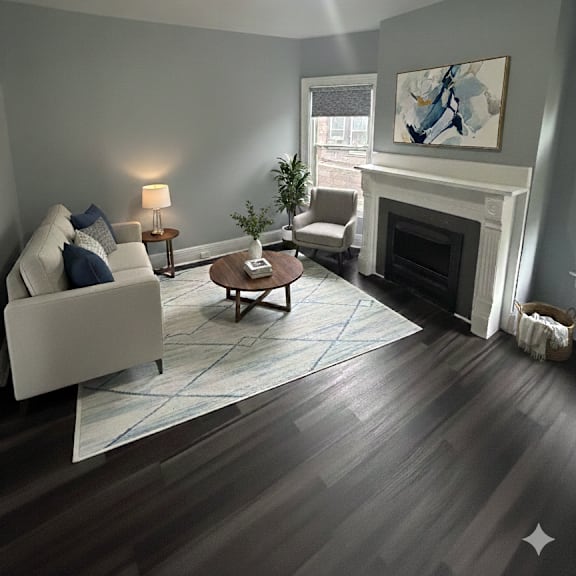 a living room with a fireplace and a painting on the wall.