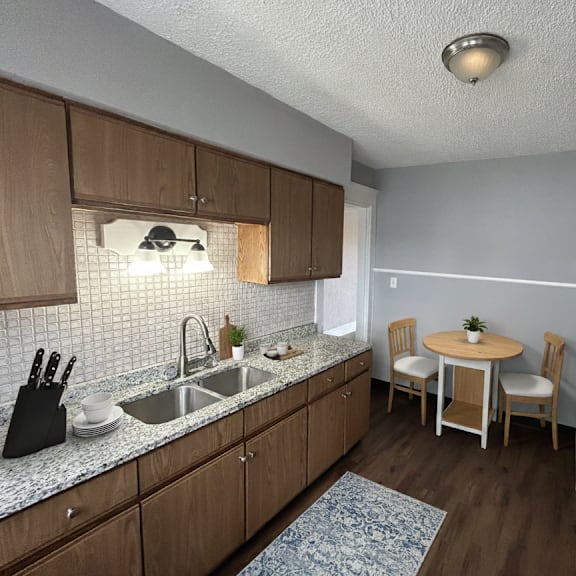 a kitchen with wooden cabinets and a white fridge.