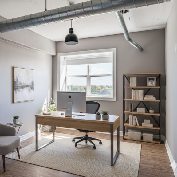 a room with a desk, chair, and bookshelf.