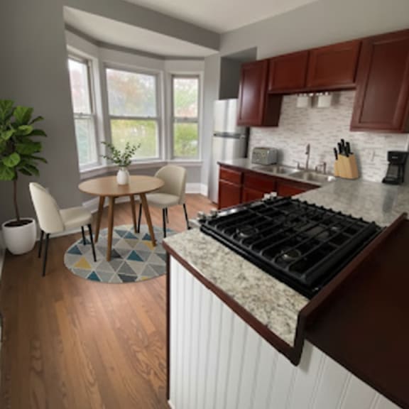 a kitchen with brown cabinets and a white countertop.