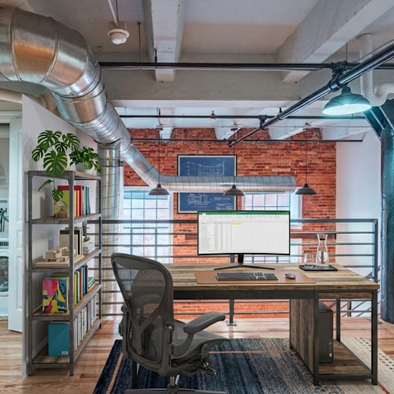 a room with a desk, chair, and a washing machine.