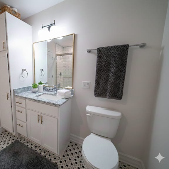 a white toilet is in a bathroom with a sink and mirror.