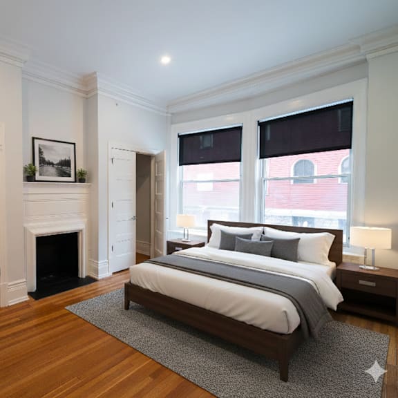 a bedroom with a large bed and a fireplace.