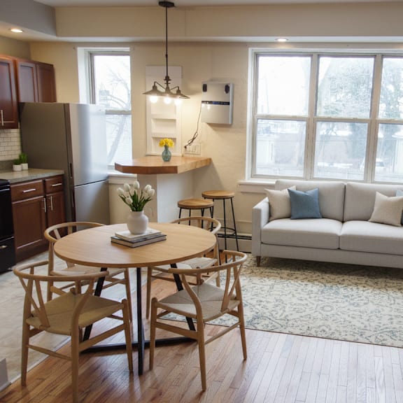 a well-lit, modern living room with a dining table and chairs.