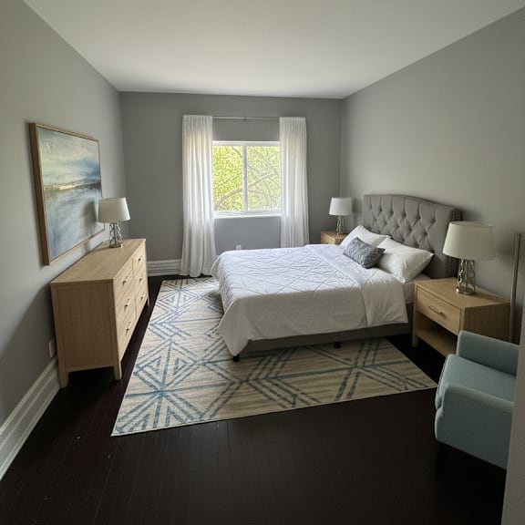 a bedroom with a large bed and a window with curtains.