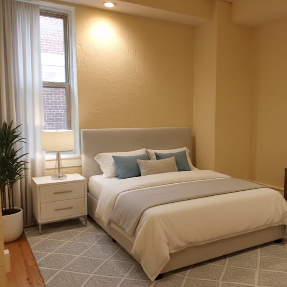 a bedroom with a large bed, a nightstand, and a mirror.