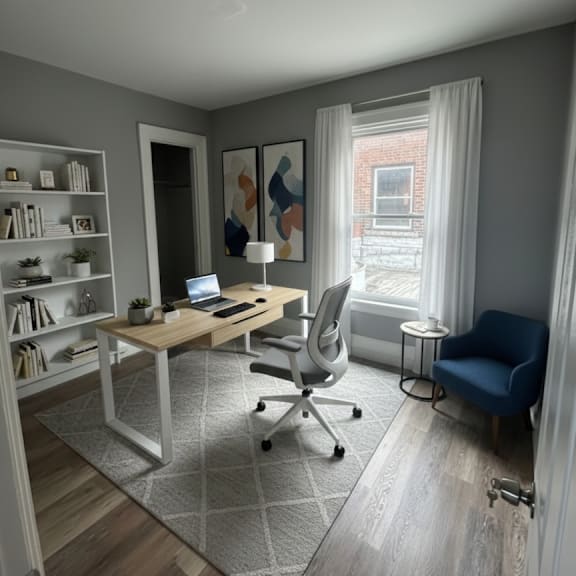 a room with a desk, chair, and bookshelf.