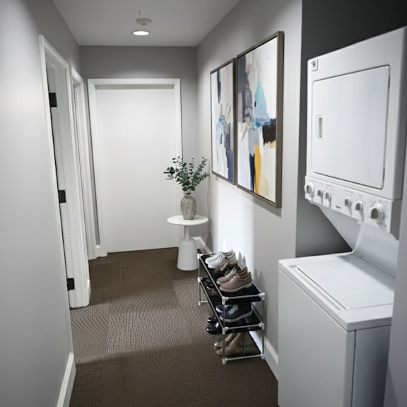 a hallway with a washing machine on the wall.