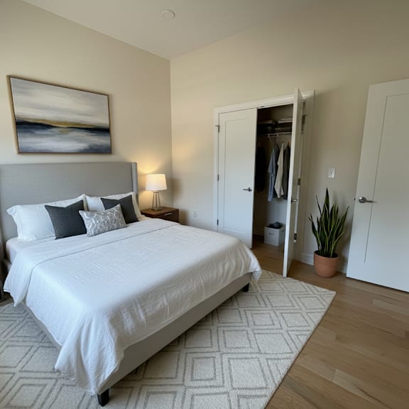 a bedroom with a large bed and a painting on the wall.