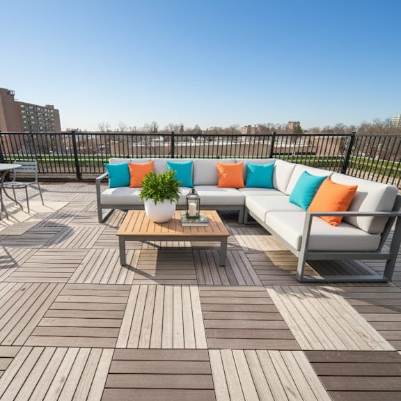 a wooden deck with a white couch and a coffee table.