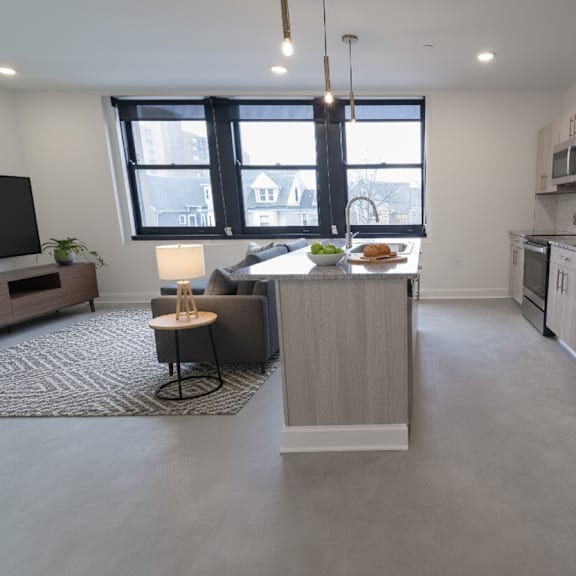 a modern kitchen with a refrigerator, microwave, and oven.