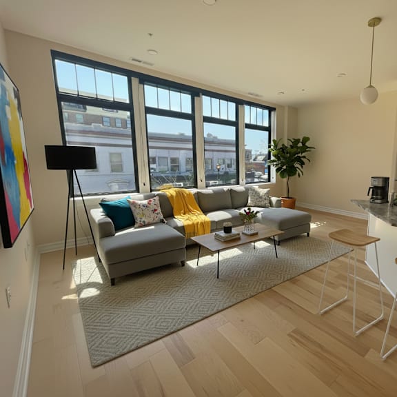 a living room with a grey couch and a coffee table.