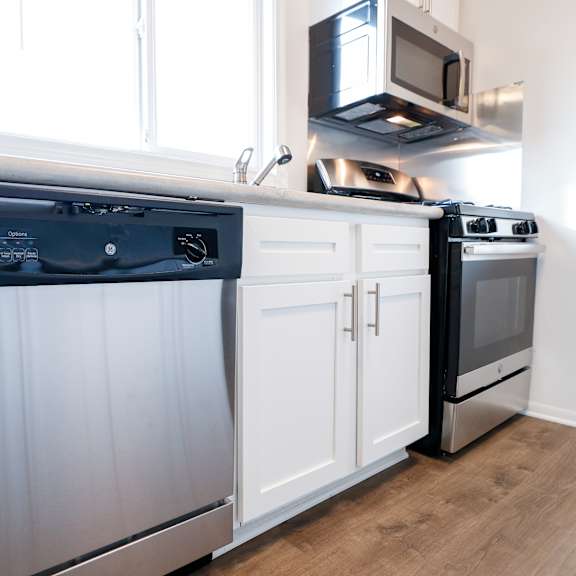 a kitchen with a dishwasher and a stove and a microwave