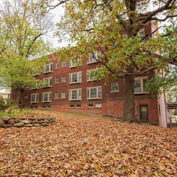 a red brick building with trees in front of it