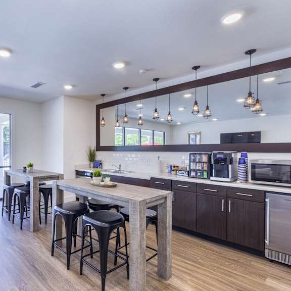 a living room with a kitchen and a dining table at aventura at towne centre, missouri, 63011
