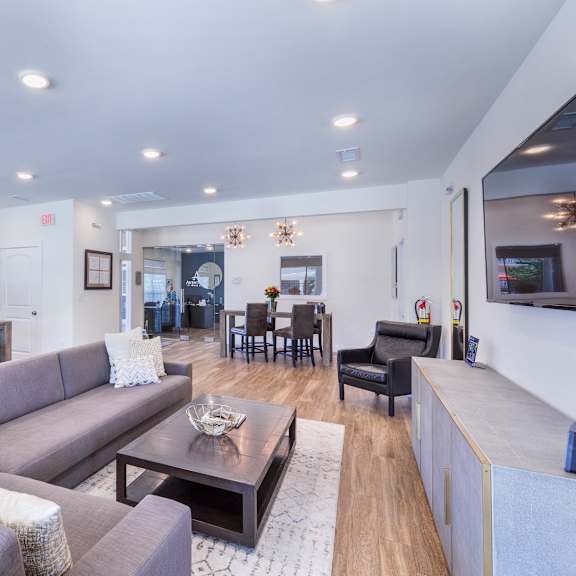 a living room with a couch and a table at aventura at towne centre, ellisville, mo