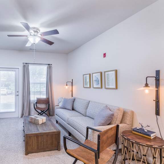 a living room with a couch and a tv at aventura at towne centre, ellisville, missouri