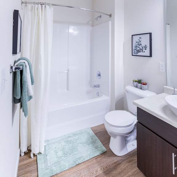 a bathroom with a shower and a toilet and a sink at aventura at towne centre, ellisville, 63011