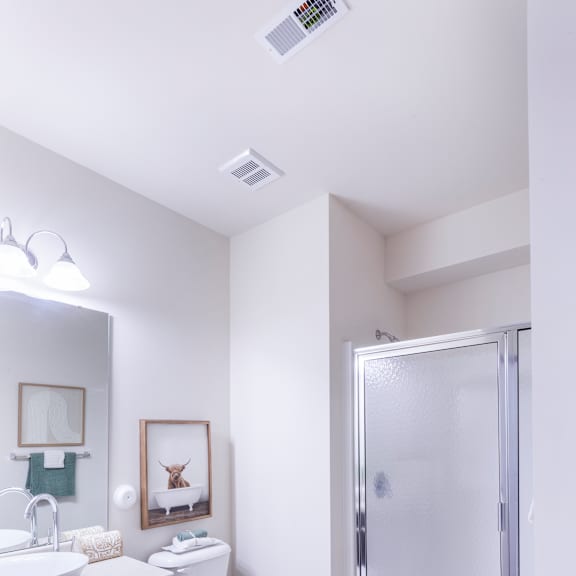 a bathroom with a shower and a toilet and a sink at aventura at towne centre, missouri, 63011