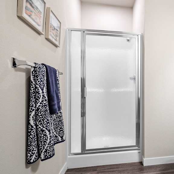 a bathroom with a shower and a toilet and a sink  at aventura at wentzville, wentzville, 63385