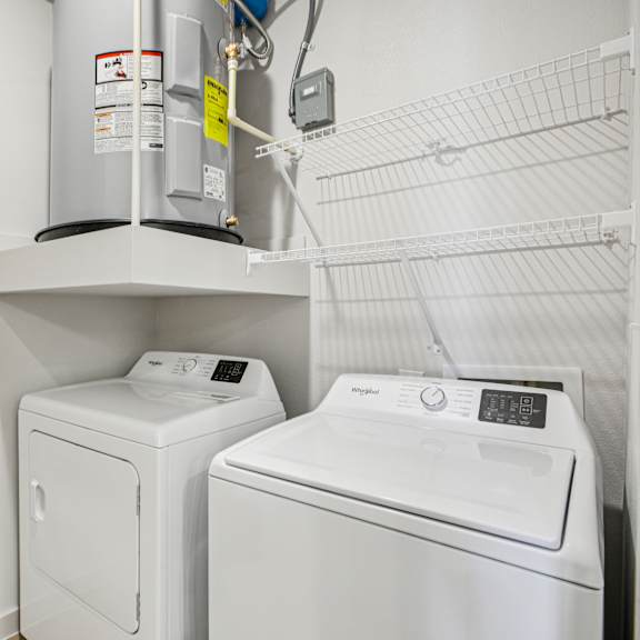 Thumbnail 28 of 37 A wall-mounted washer and dryer are installed in a small room. at ThreeTwenty at the Vybe Apartments, Texas