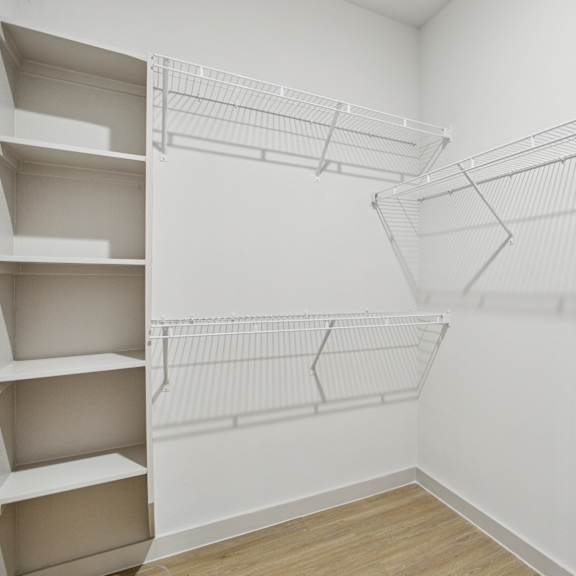 Thumbnail 31 of 37 Empty white shelves in a room. at ThreeTwenty at the Vybe Apartments, Kyle, Texas