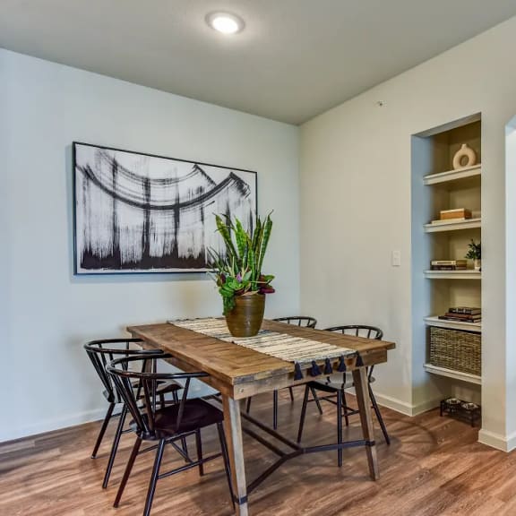 Thumbnail 5 of 11 Dining area with wood table and builtin shelving at High Point Preserve Apartments, Austin, TX