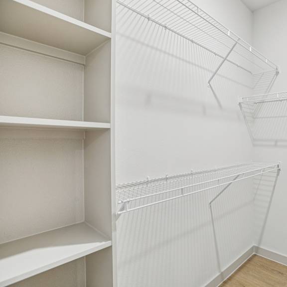 Thumbnail 33 of 37 Empty white shelves in a room. at ThreeTwenty at the Vybe Apartments, Kyle, TX, 78640