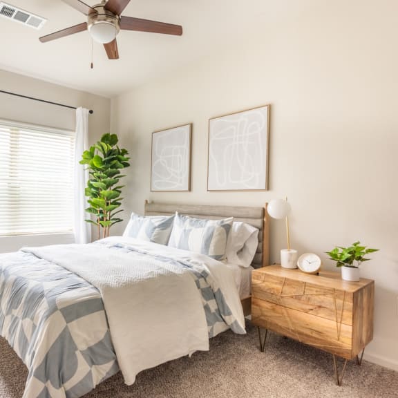 Thumbnail 10 of 15 a bedroom with a large bed and a ceiling fan at Three Hills, Austin Texas