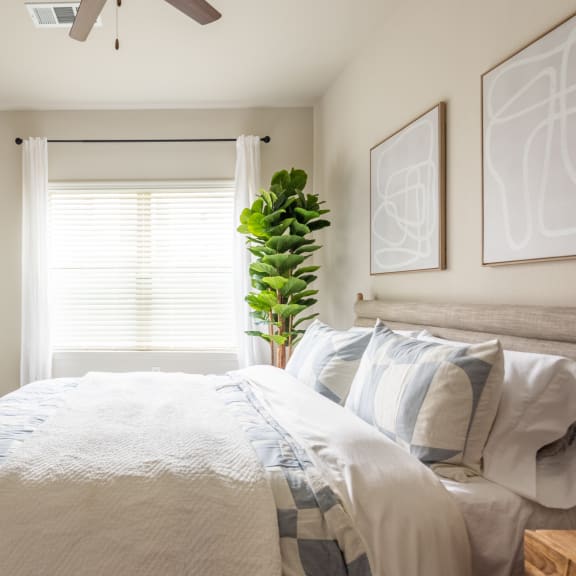 Thumbnail 11 of 15 a bedroom with white walls and a white bed with a blue and white comforter at Three Hills, Austin, TX 78747