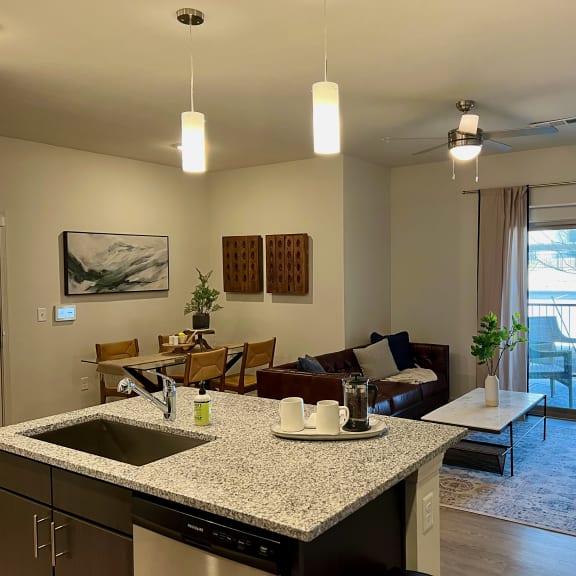 Thumbnail 5 of 16 Open kitchen island overlooking living room and dining space 1 at High Point Preserve Apartments, Austin, TX