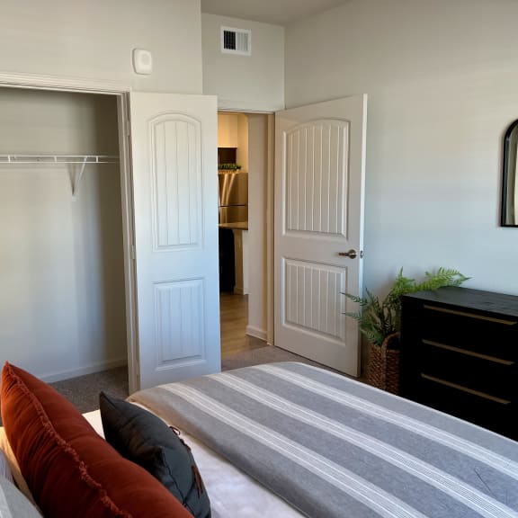 Thumbnail 8 of 16 Bedroom with open closet and adjacent hallway 1 at High Point Preserve Apartments, Texas