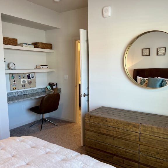 Thumbnail 13 of 16 Bedroom with built in desk nook and wood dresser 1 at High Point Preserve Apartments, Austin, Texas