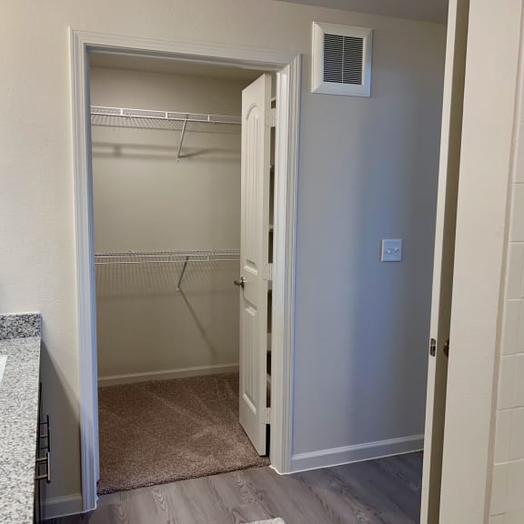 Thumbnail 16 of 16 Walk-in closet with wire shelving and carpeted floor at High Point Preserve Apartments, Texas, 78724