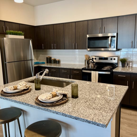 Thumbnail 3 of 13 Kitchen island with granite countertop and modern appliances 1 at High Point Preserve Apartments, Austin, TX