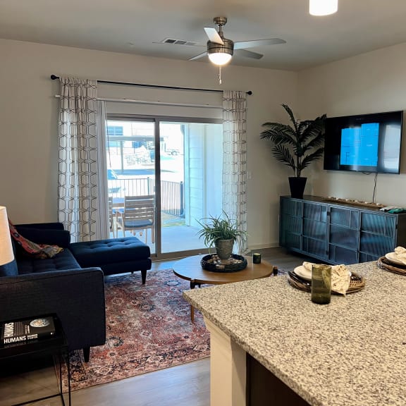 Thumbnail 4 of 13 Open living and dining area with blue furnishings at High Point Preserve Apartments, Austin, 78724