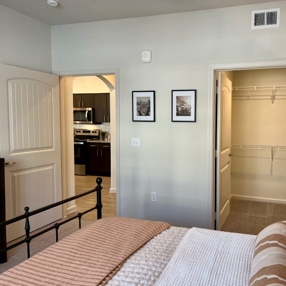 Thumbnail 12 of 13 Bedroom with black metal bed frame and walk-in closet 2 at High Point Preserve Apartments, Austin, Texas