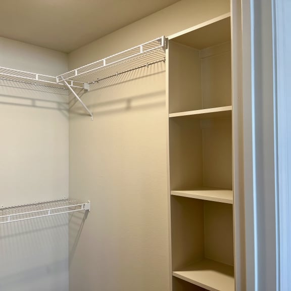 Thumbnail 13 of 13 Walk-in closet with wire shelving and wood cubbies 2 at High Point Preserve Apartments, Austin