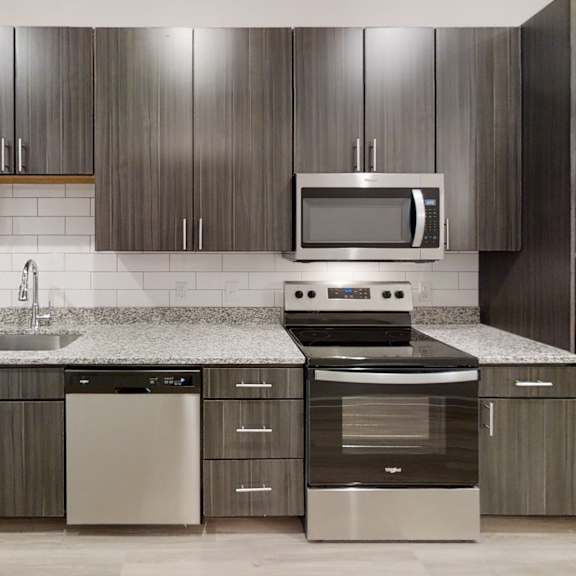 Thumbnail 2 of 5 a kitchen with dark wood cabinets and white countertops