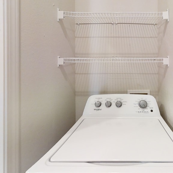 Thumbnail 4 of 8 a washer and dryer in the laundry room